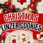 Linzer cookies with jam filling and powdered sugar ona serving dish with christmas decorations all around them.