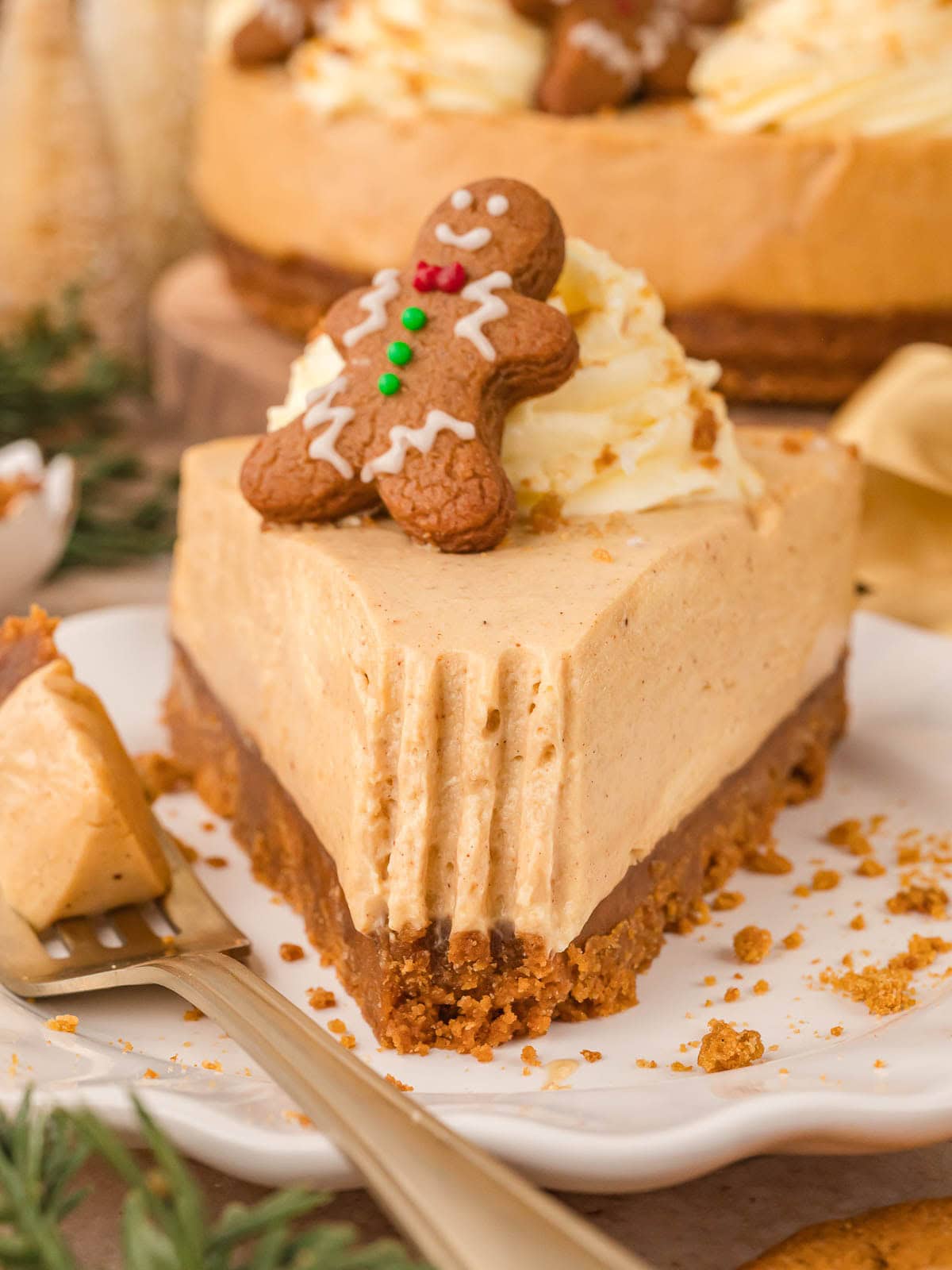 Close-up of No Bake Gingerbread Cheesecake slice with a bite taken out showing smooth texture and gingersnap crust.