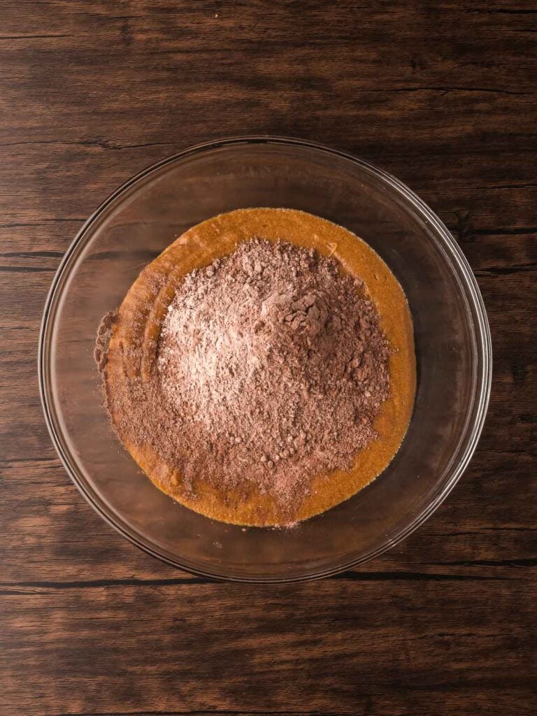 Cocoa and flour mixture poured into the wet cookie batter to make Double Chocolate Chunk Cookie dough.