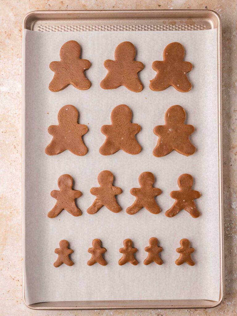 Baking sheet with cut-out Gingerbread Man Cookies dough before baking.