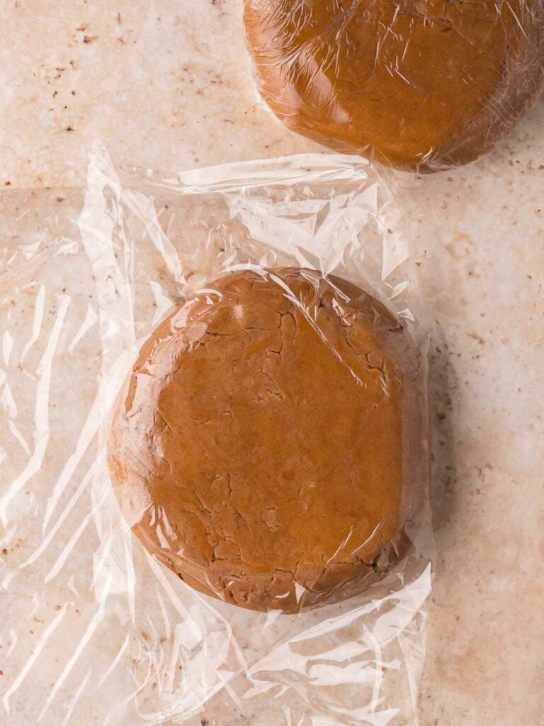 Gingerbread Man Cookies dough wrapped in plastic wrap and ready to chill.