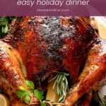 Whole herb butter roast turkey with tied legs, rosemary, parsley and lemons by Tessie's Table.