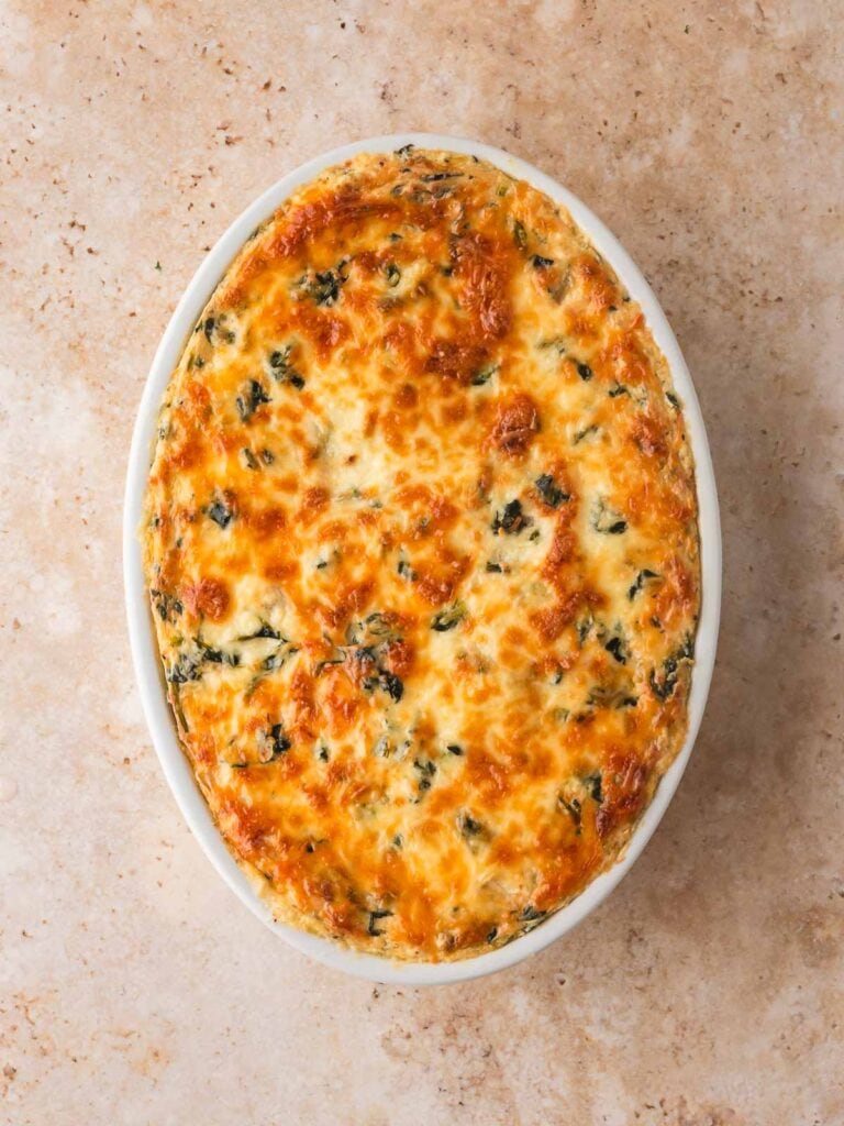 Fully baked spinach artichoke dip with a golden, bubbly top.