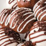 Rich Oreo truffles coated in white and milk chocolate, drizzled with contrasting chocolate and topped with crushed Oreo crumbs.