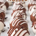Chocolate dipped Oreo truffles on a white plate.