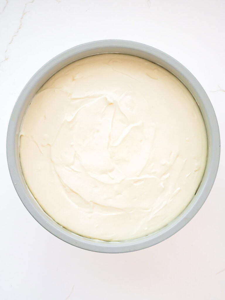 Cheesecake layer in the springform pan before adding the cookie butter topping.