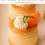 Smoked salmon vol au vent with dill cream cheese and a sprig of dill on a white tray by Tessie's Table.
