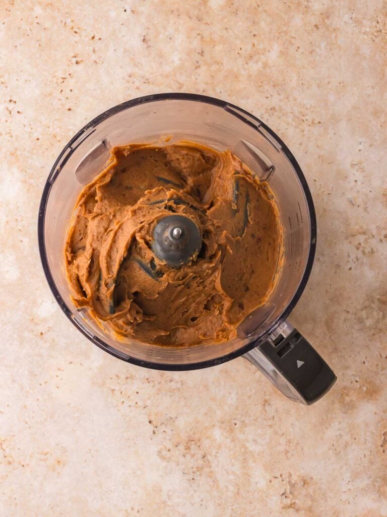 Smooth blended mixture of dates and PB2 in a food processor for the protein bar base.