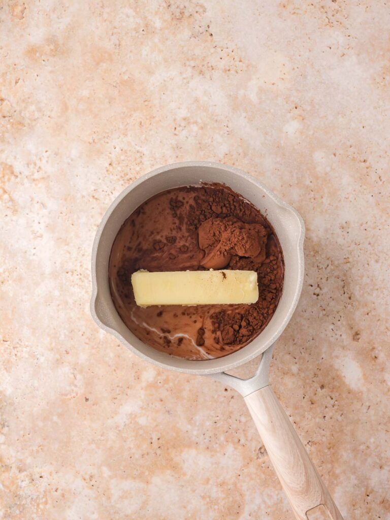 Milk, cocoa, and butter added to a saucepan. 