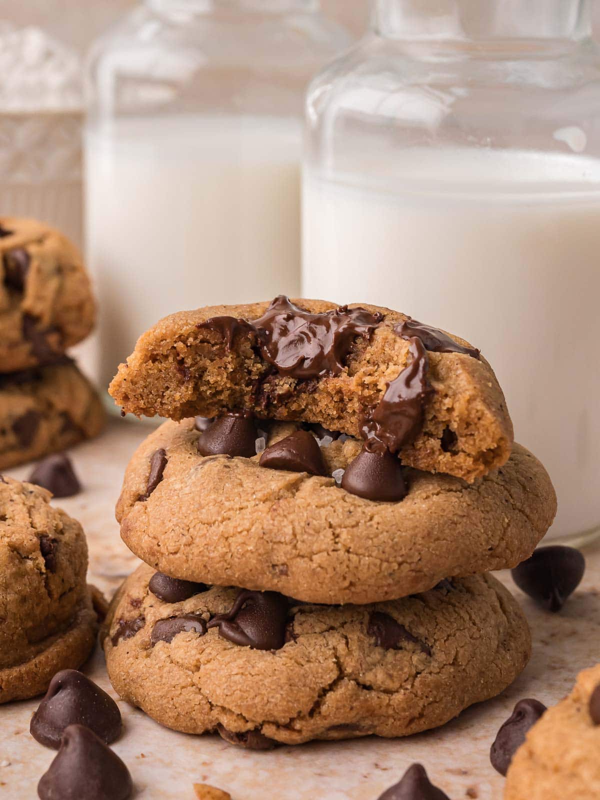 Brown butter chocolate chip cookies stacked with one cookie broken open showing soft, chewy center and melted chocolate.