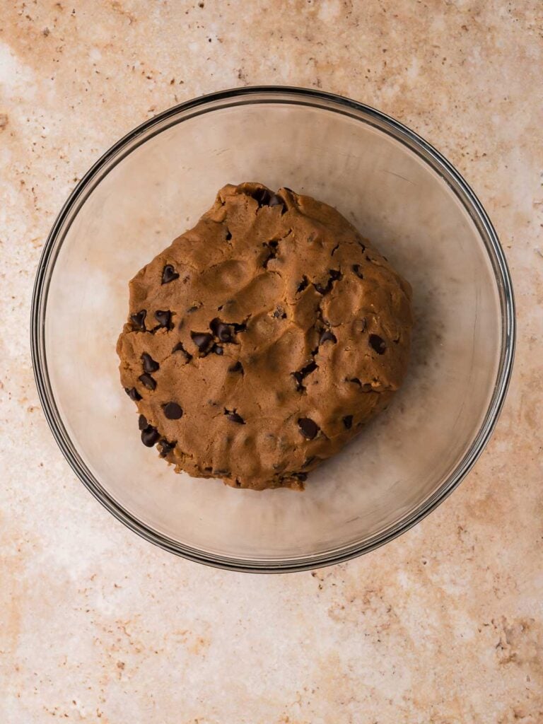 Finished brown butter chocolate chip cookie dough resting in a mixing bowl.