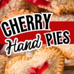 Heart-shaped cherry hand pies with flaky golden crusts and red cherry filling, topped with coarse sugar and styled for a Valentine’s Day dessert pin.