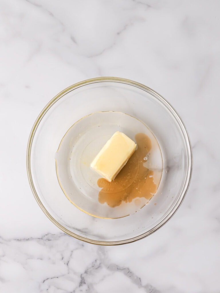 Butter and corn syrup in a glass bowl for fondant filling.

