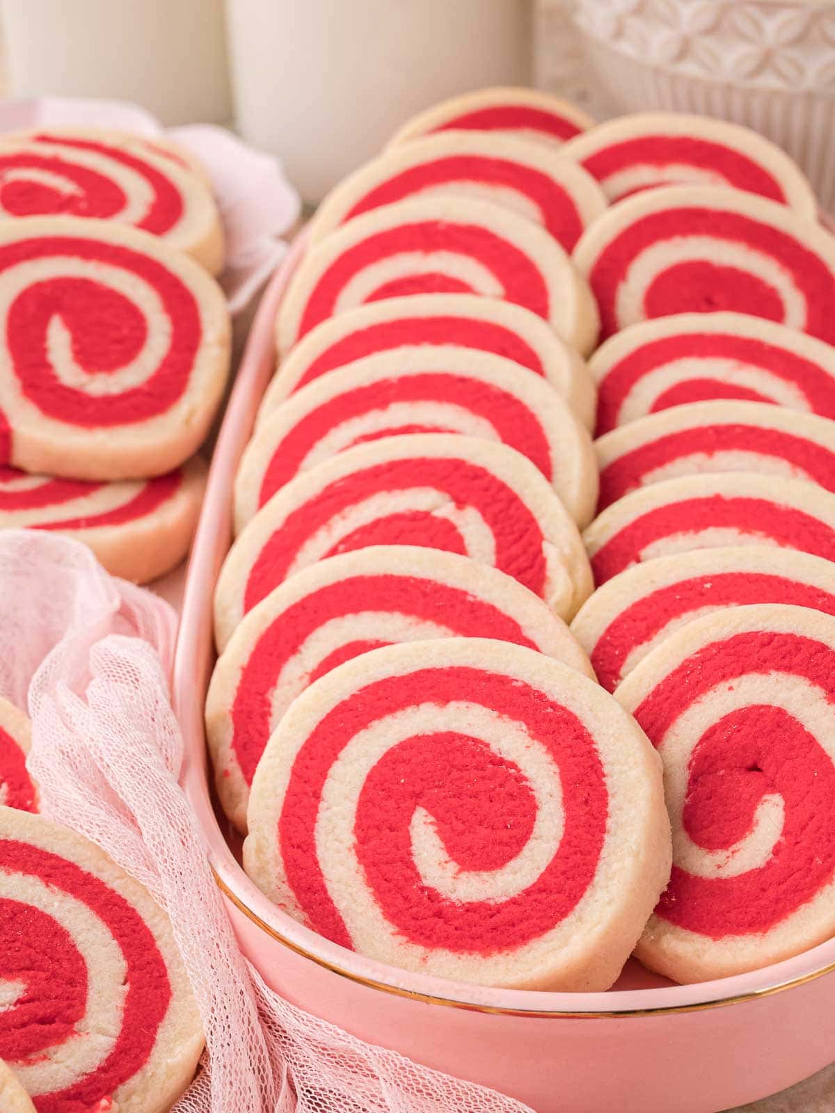 Pinwheel cookies arranged in a pink serving dish for Valentine’s Day desserts.