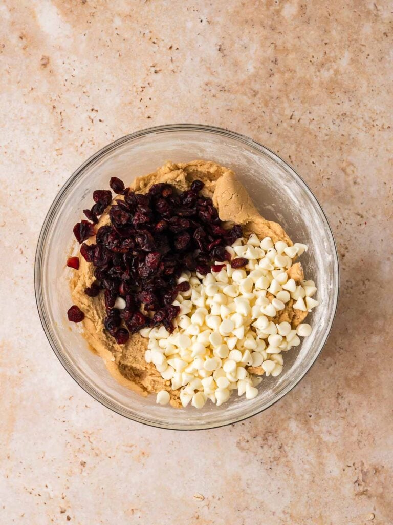 White chocolate chips and dried cranberries added to cookie dough before mixing.