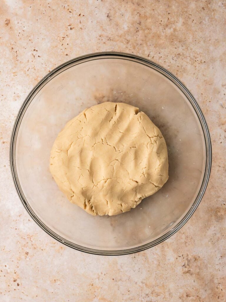 Finished heart jam cookie dough formed into a smooth ball in a mixing bowl.