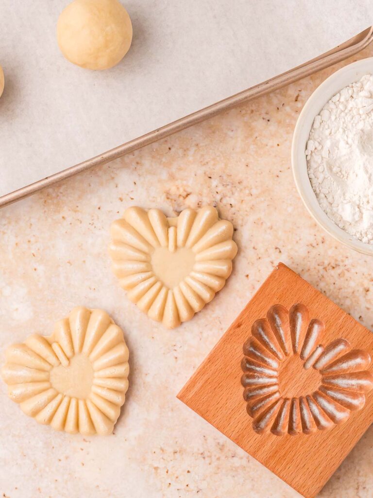 Stamped heart cookie released from the mold and removed carefully.