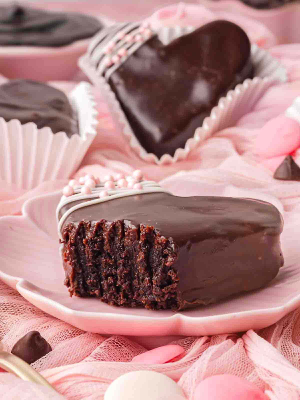 Chocolate heart brownie cut in half showing a fudgy brownie center with chocolate coating.