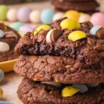 Stack of Cadbury Egg brownie cookies showing soft, fudgy centers and melted chocolate pieces.