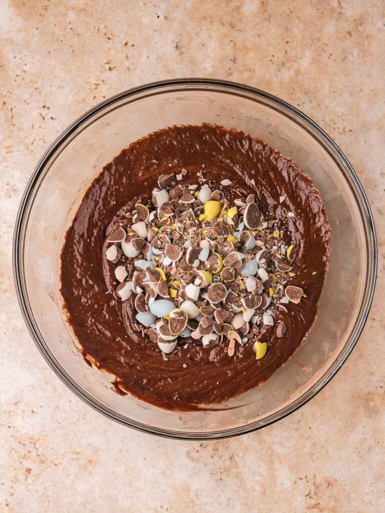 Chopped Cadbury mini eggs folded into thick brownie cookie dough.
