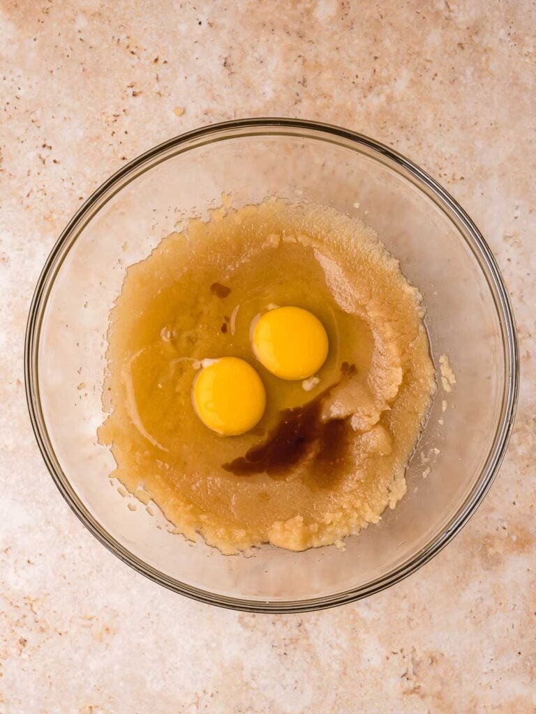 Eggs and vanilla added to sugar and butter mixture for Cadbury egg brownies batter.