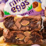 Close up of Cadbury egg brownies showing gooey centers and chunks of mini eggs inside.