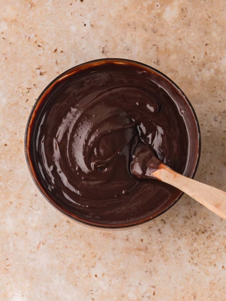 Chocolate ganache in a bowl ready to be chilled before scooping and roll into Chocolate Baileys Truffles.