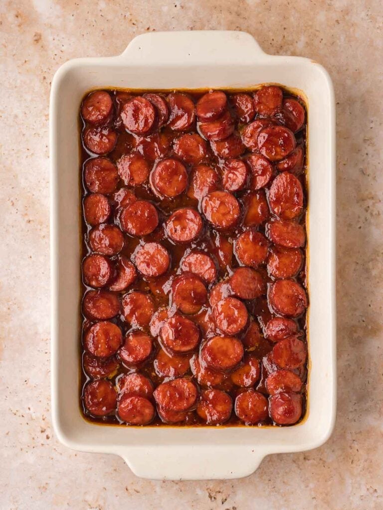 BBQ sausage bites baked until caramelized with thick sticky BBQ sauce.