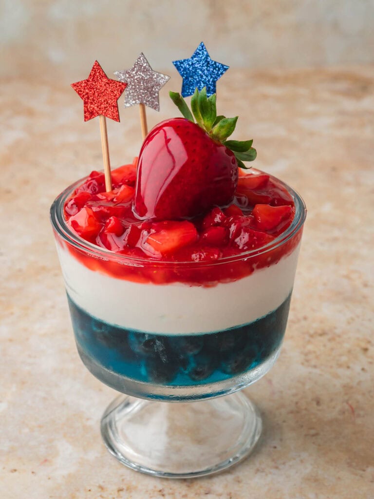 Red White and Blue Dessert Cup topped with a glazed strawberry and red white and blue star picks.