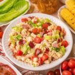 Easy BLT pasta salad served with bacon, cherry tomatoes, and lettuce for summer BBQs.