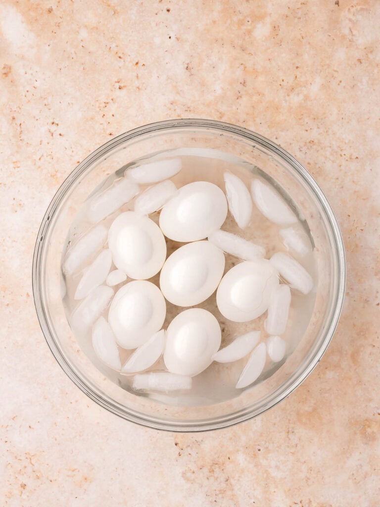 Hard boiled eggs cooling in an ice bath.