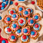 Pile of Red White and Blue Pretzel Bites on a serving tray with patriotic sprinkles and candy.
