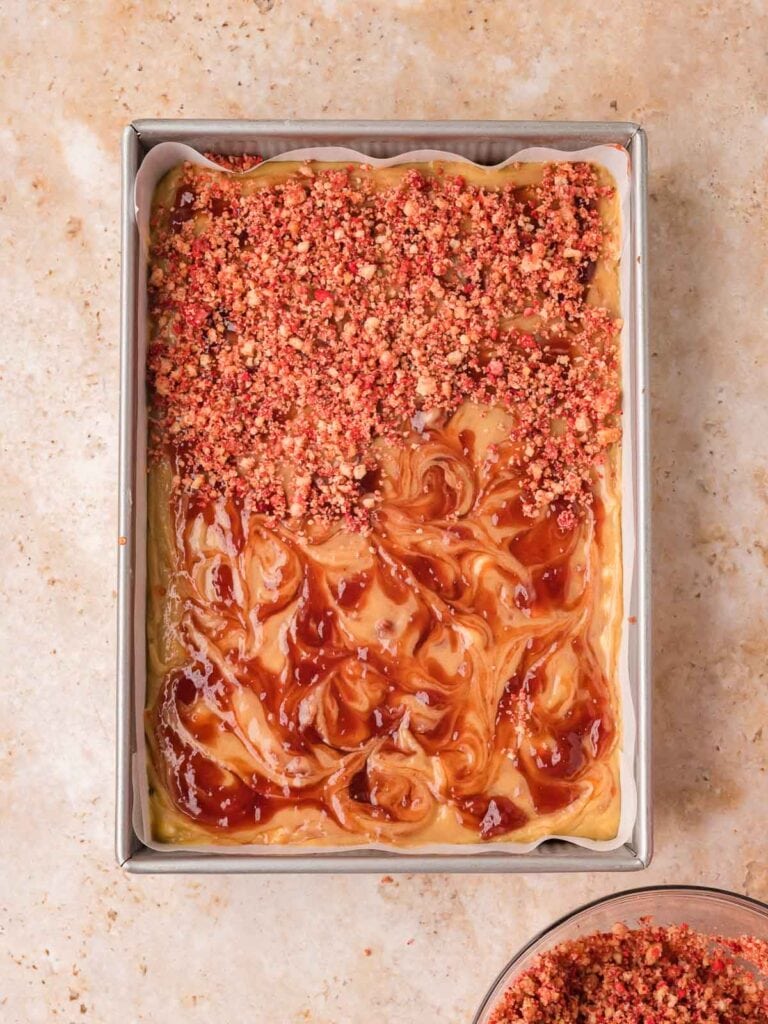 Strawberry crunch topping sprinkled over the swirled blondie batter before baking.