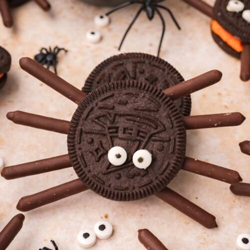 Close up overhead view of a single Oreo spider cookie with chocolate stick legs and candy eyes by Tessie's Table.