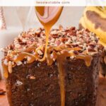 Caramel sauce being poured over a loaf of caramel pecan banana bread topped with chopped pecans.
